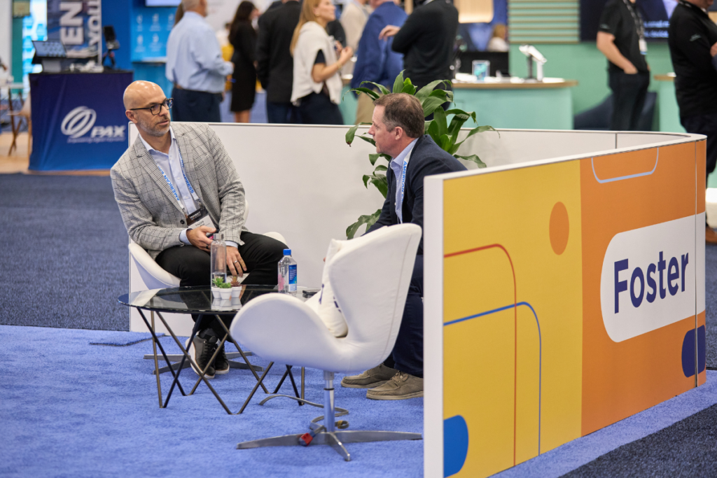 Attendees meeting on the show floor