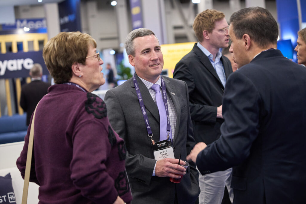 Attendees forming a partnership at TRANSACT