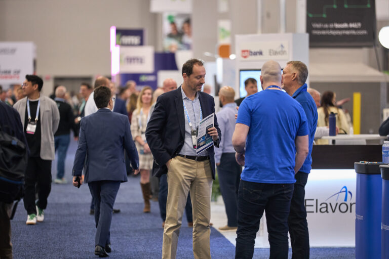 Attendees connecting on the show floor at TRANSACT