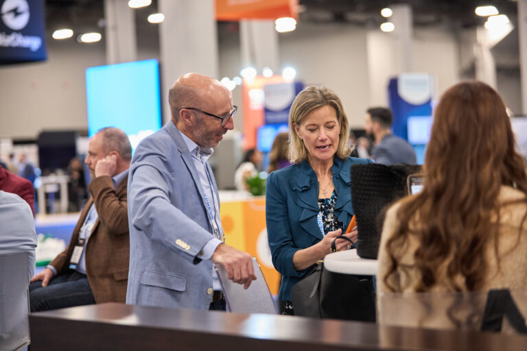 Exhibitor showing an attendee a product
