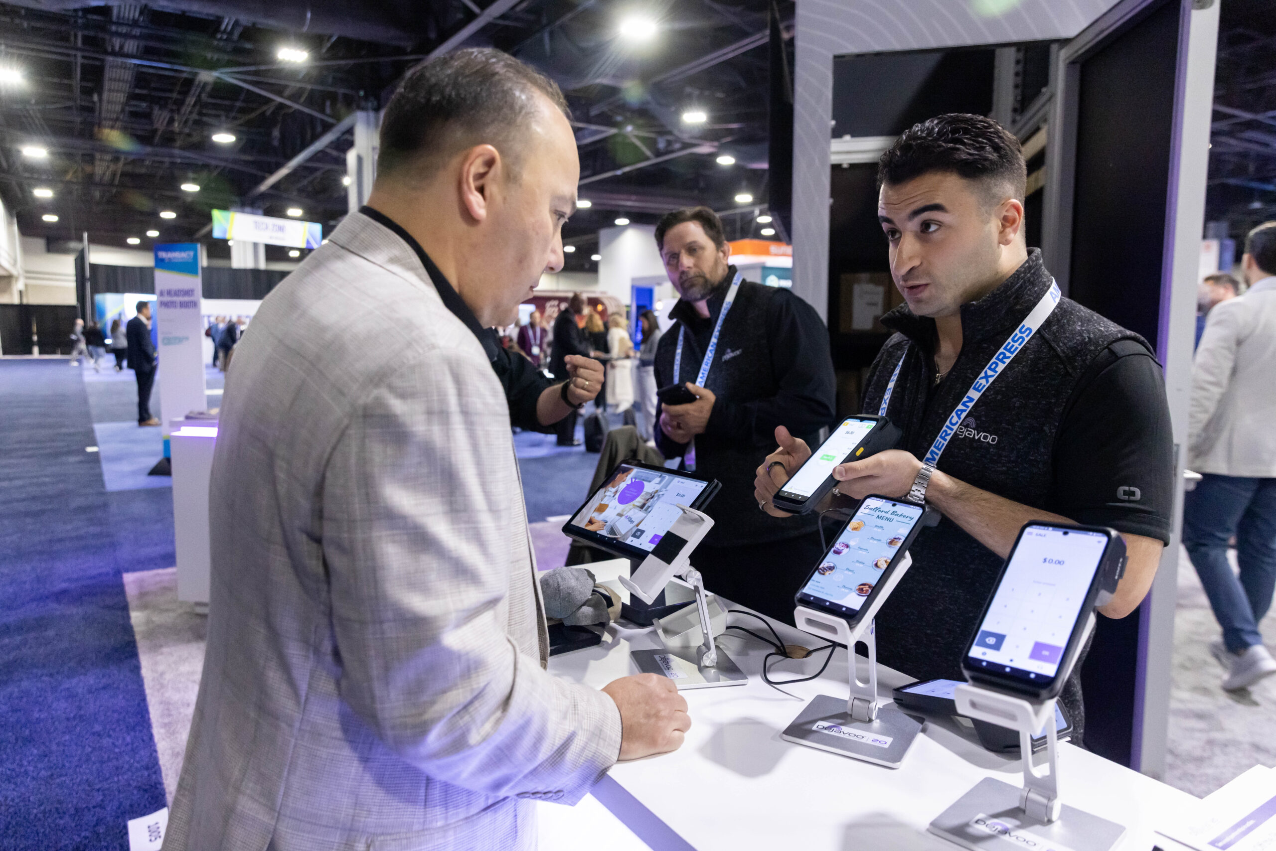 Exhibitor showing an attendee their product